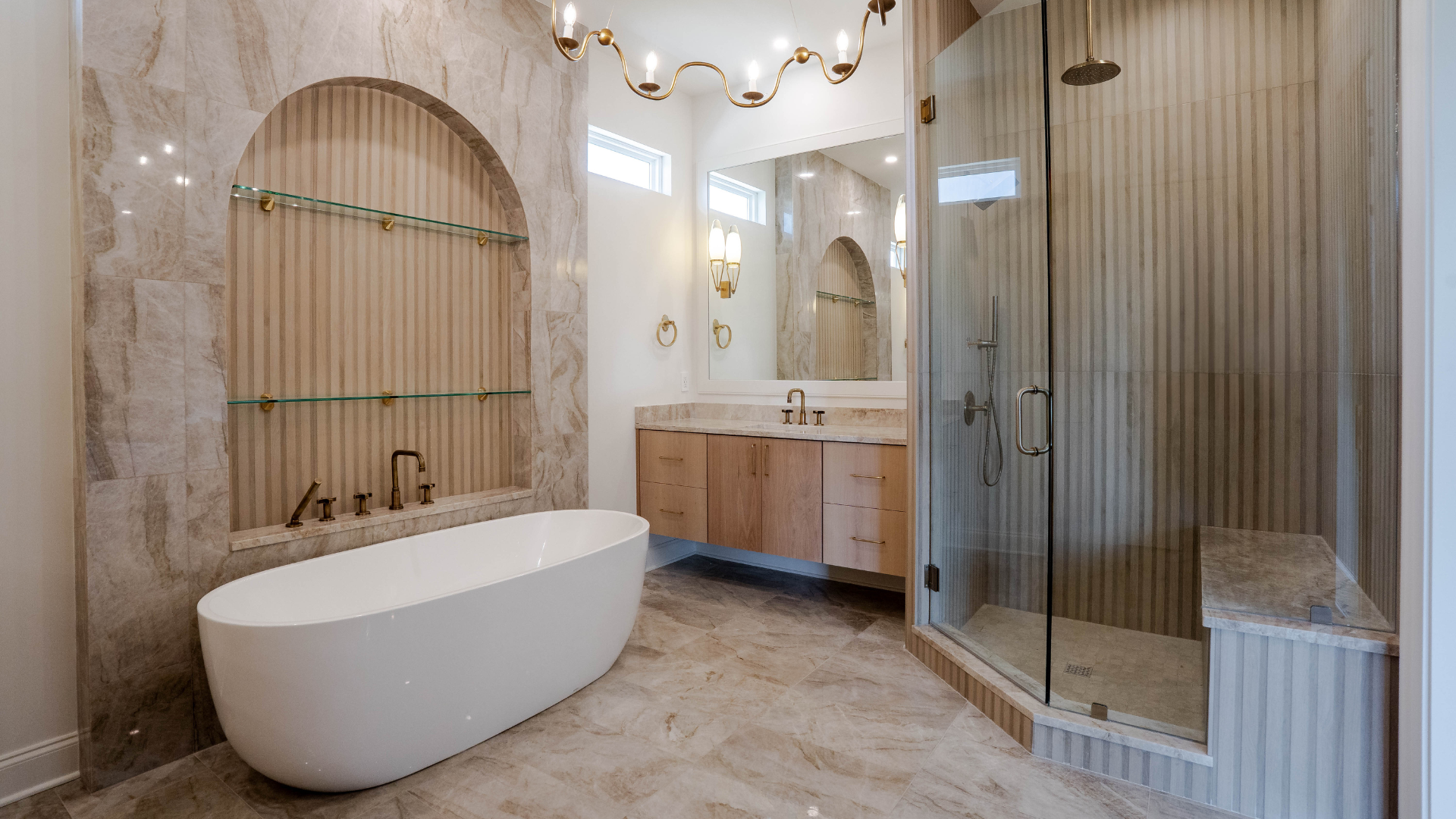Custom tiled shower with built-in niche and bench and soaker tub